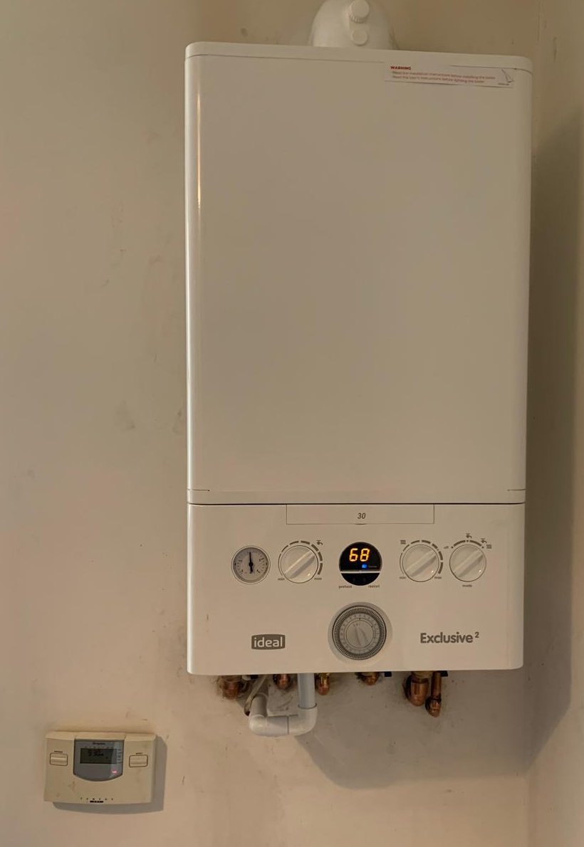 Ideal Exclusive combi boiler on a domestic wall with the display showing normal operating pressure