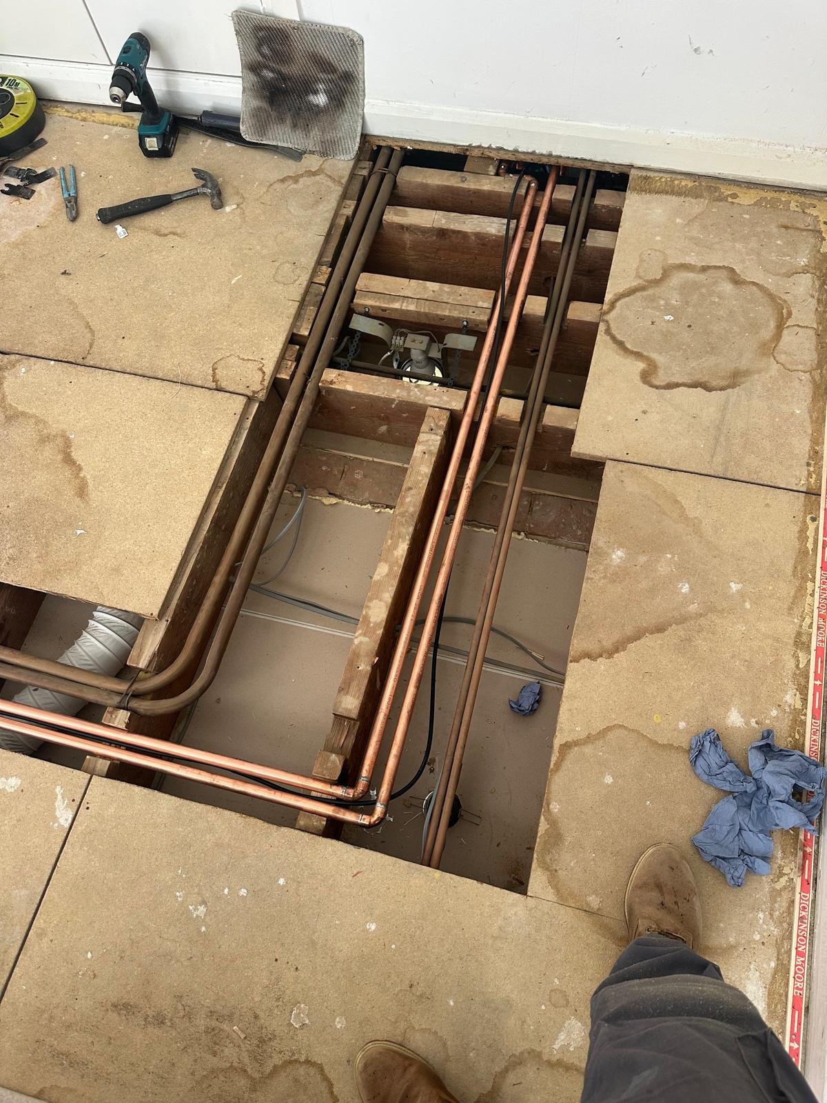 New copper central heating pipework installed between floor joists
