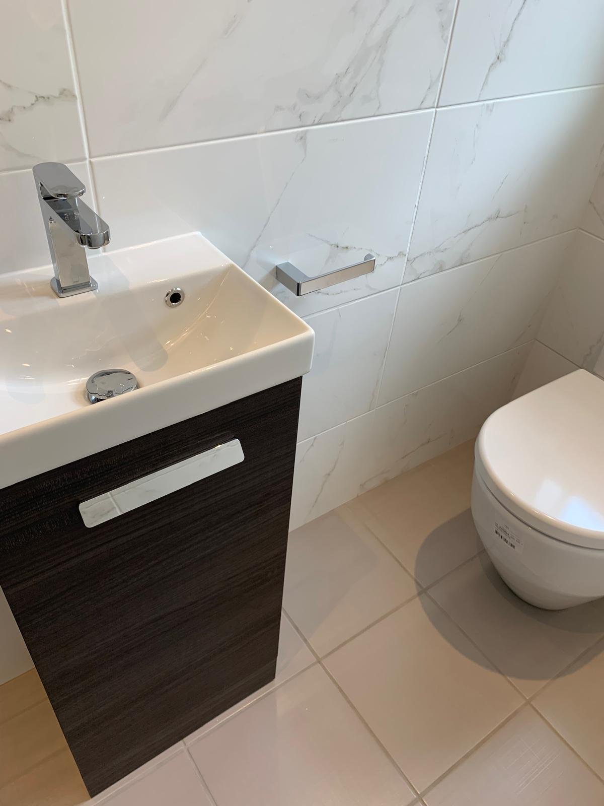Cloakroom vanity unit and basin finished in marble effect tiling