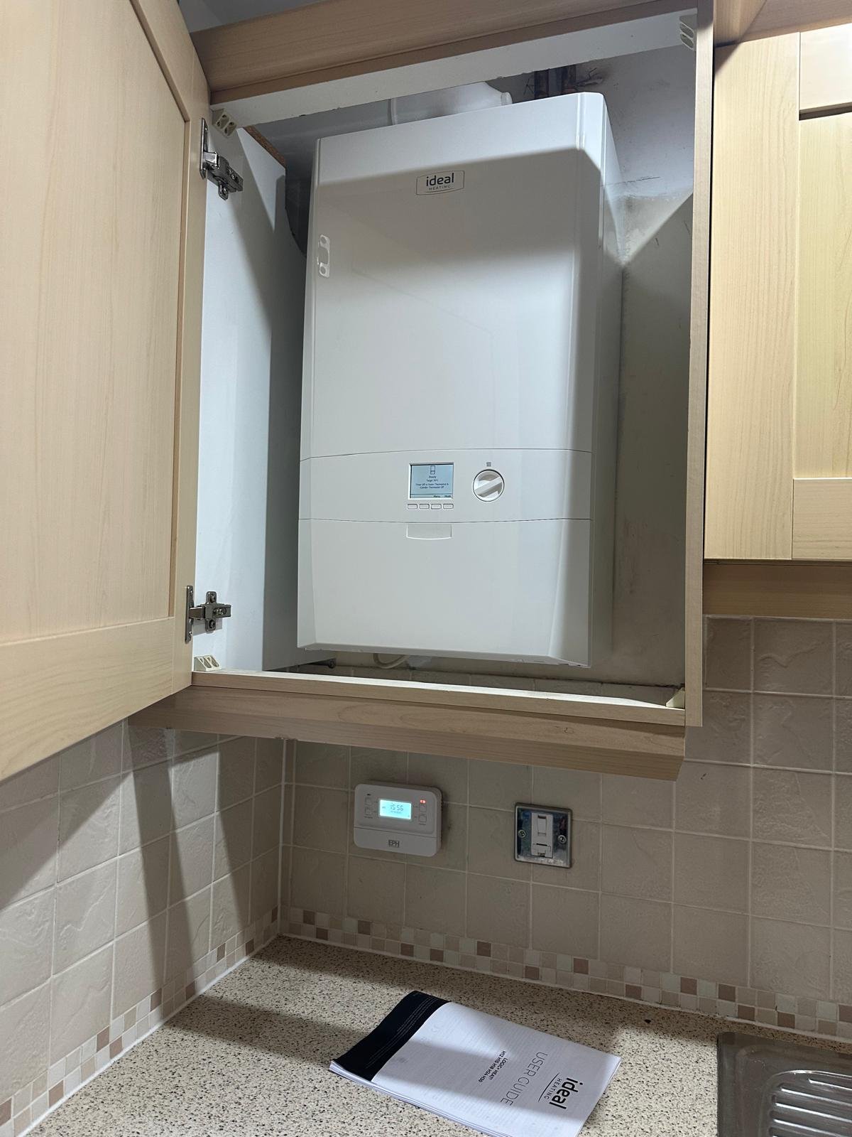 Ideal boiler serviced inside a kitchen unit with the programmer set below